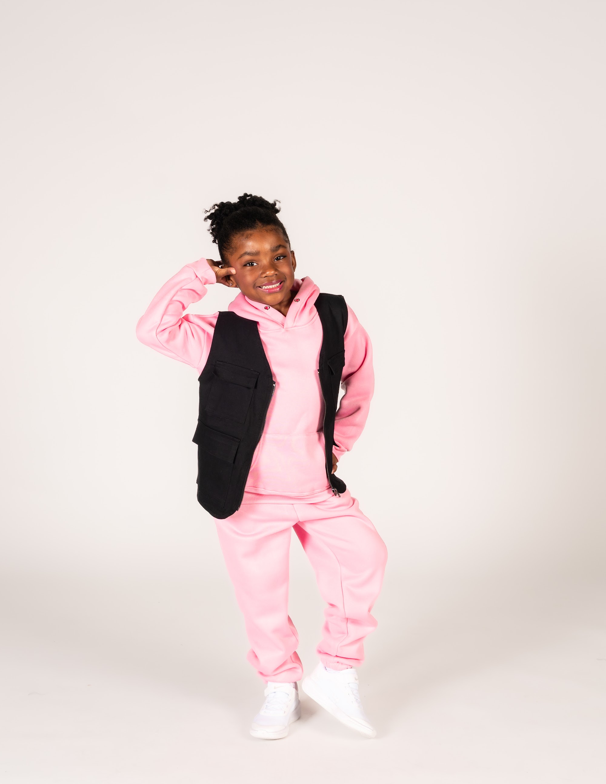 Hip Hop 1 dancer in a pink hoodie striking a pose
