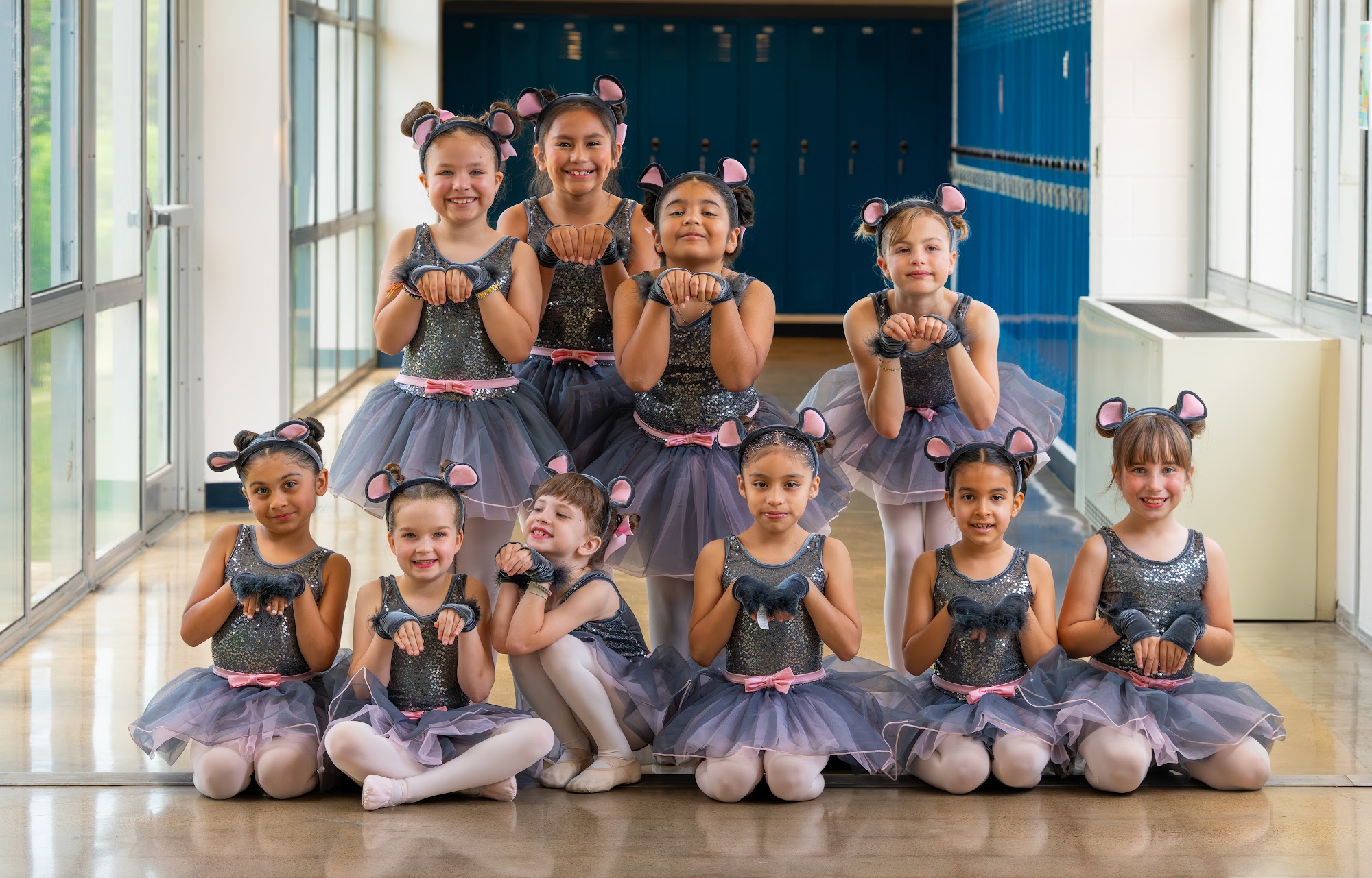 Oak Cliff Dance students in costume posed together in the studio lobby
