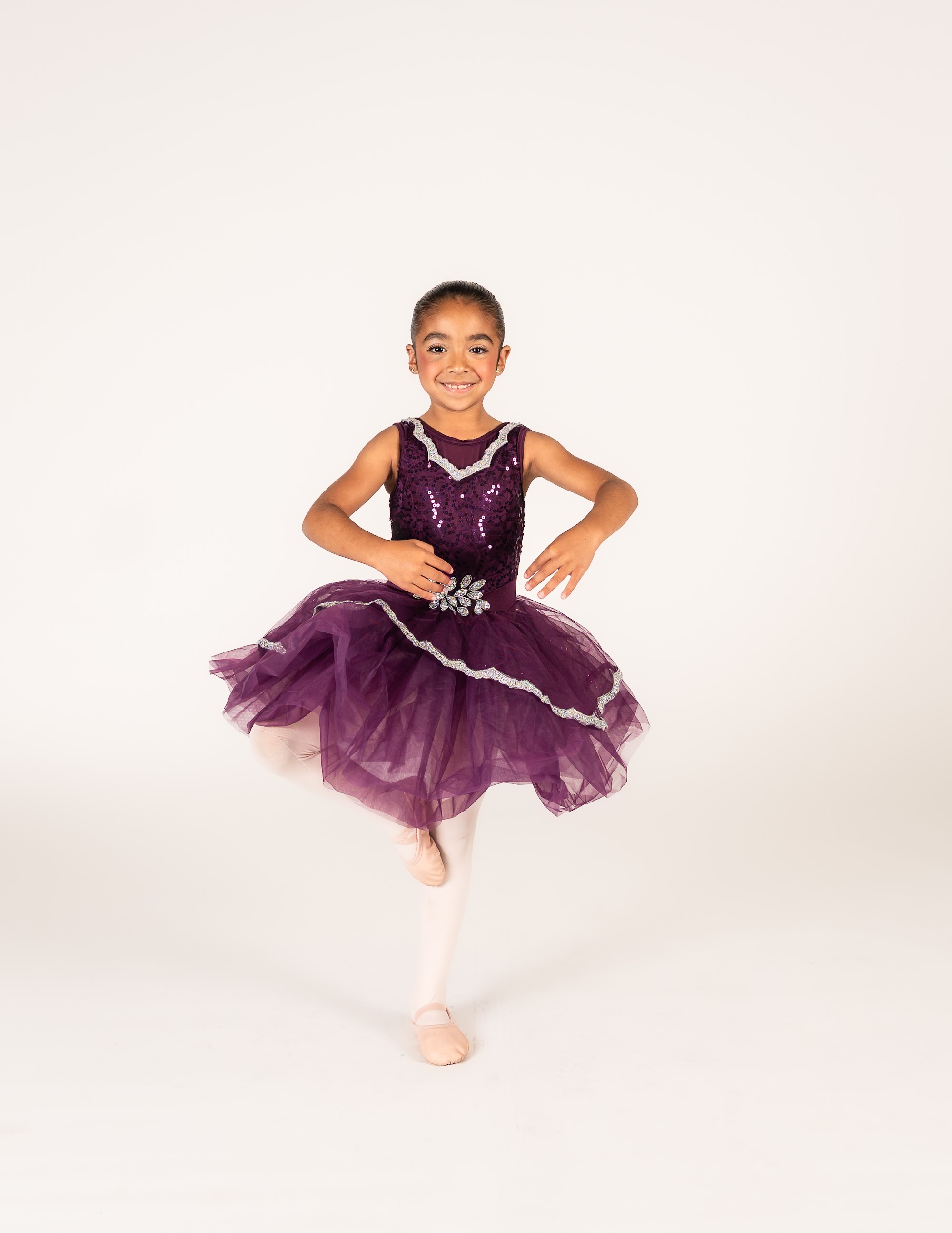 Ballet I dancer in a purple tutu in a classical pose