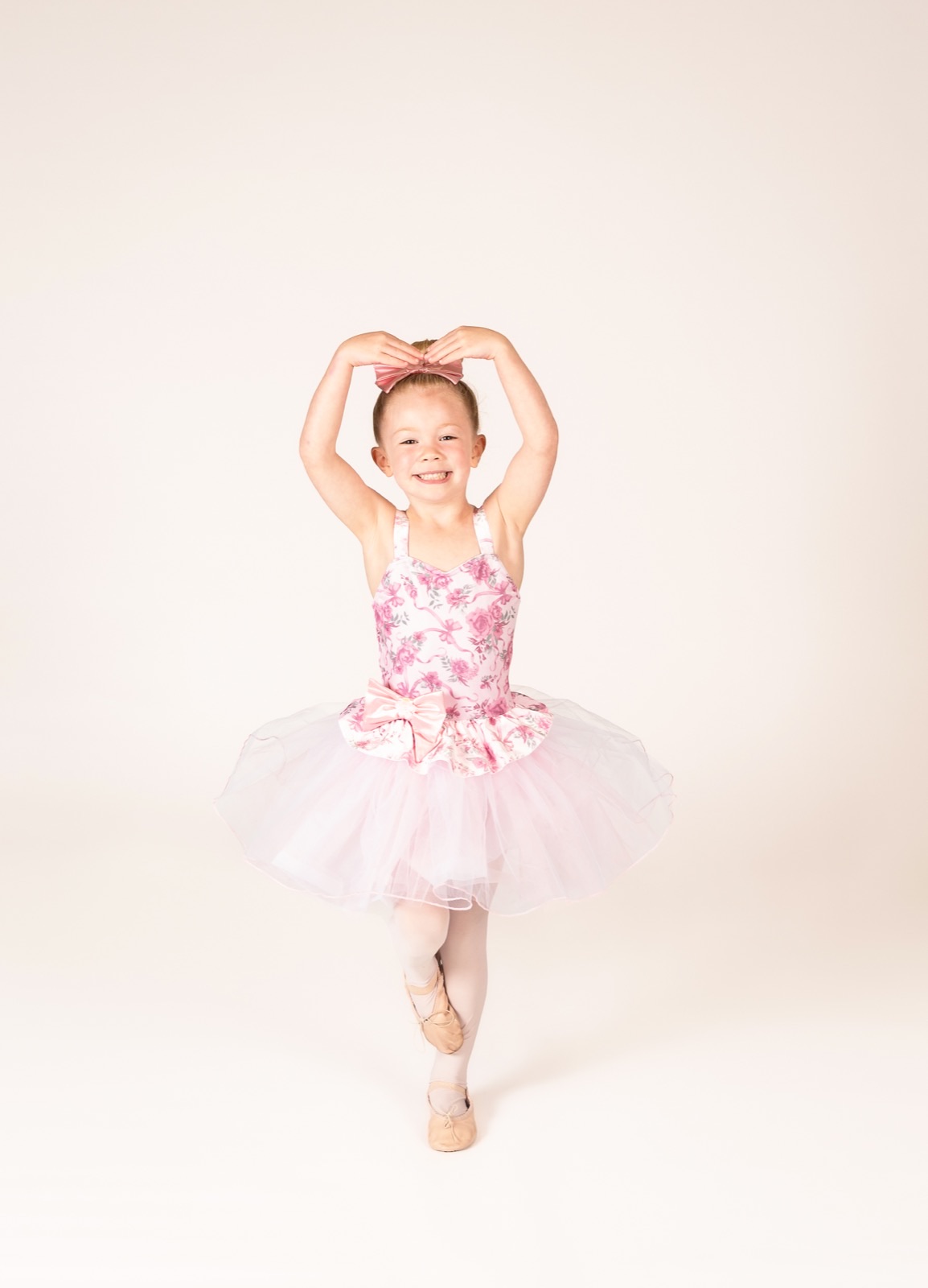 Four and five year old dancer in a pink floral tutu in passe
