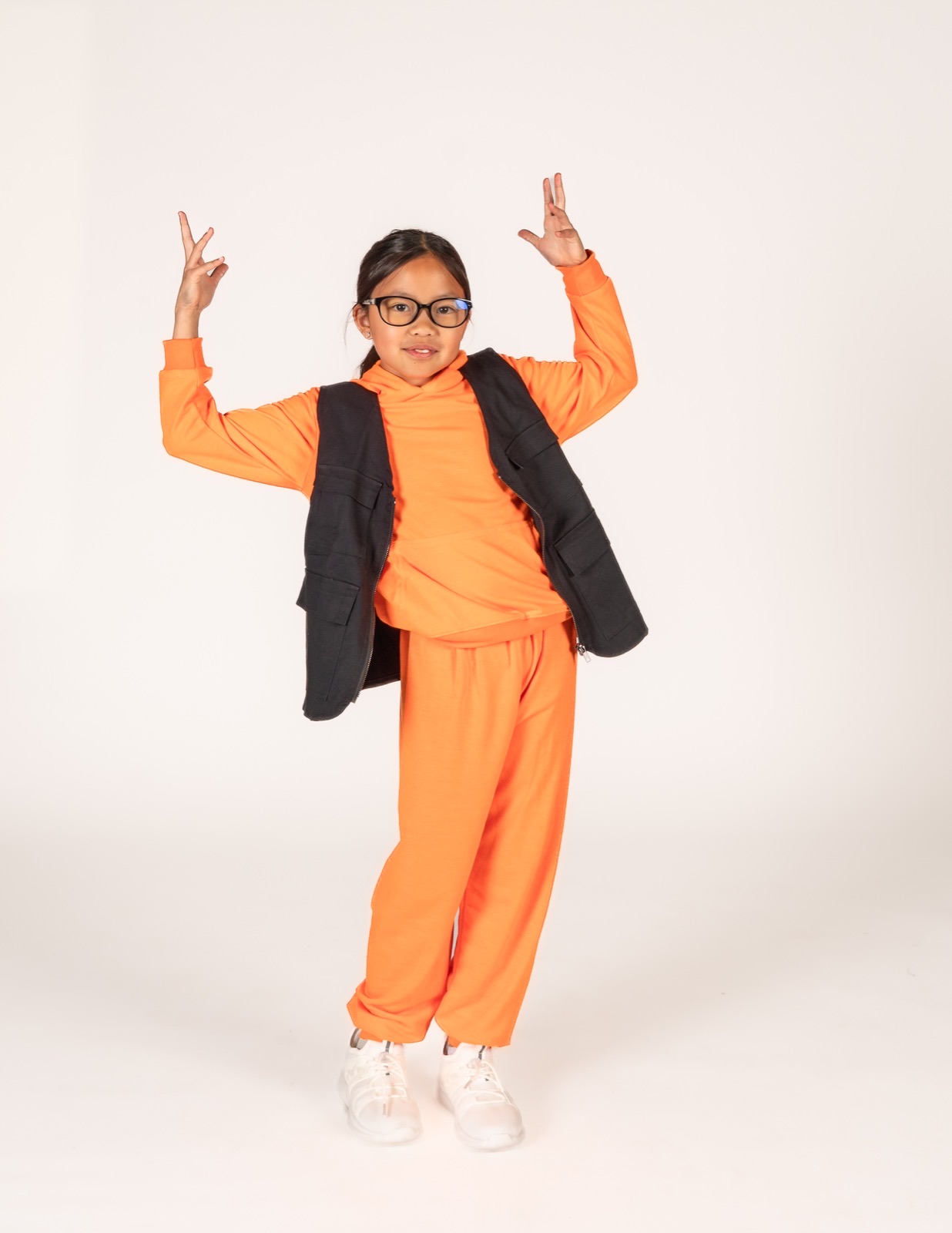 Hip Hop 3 dancer in an orange hoodie mid pose